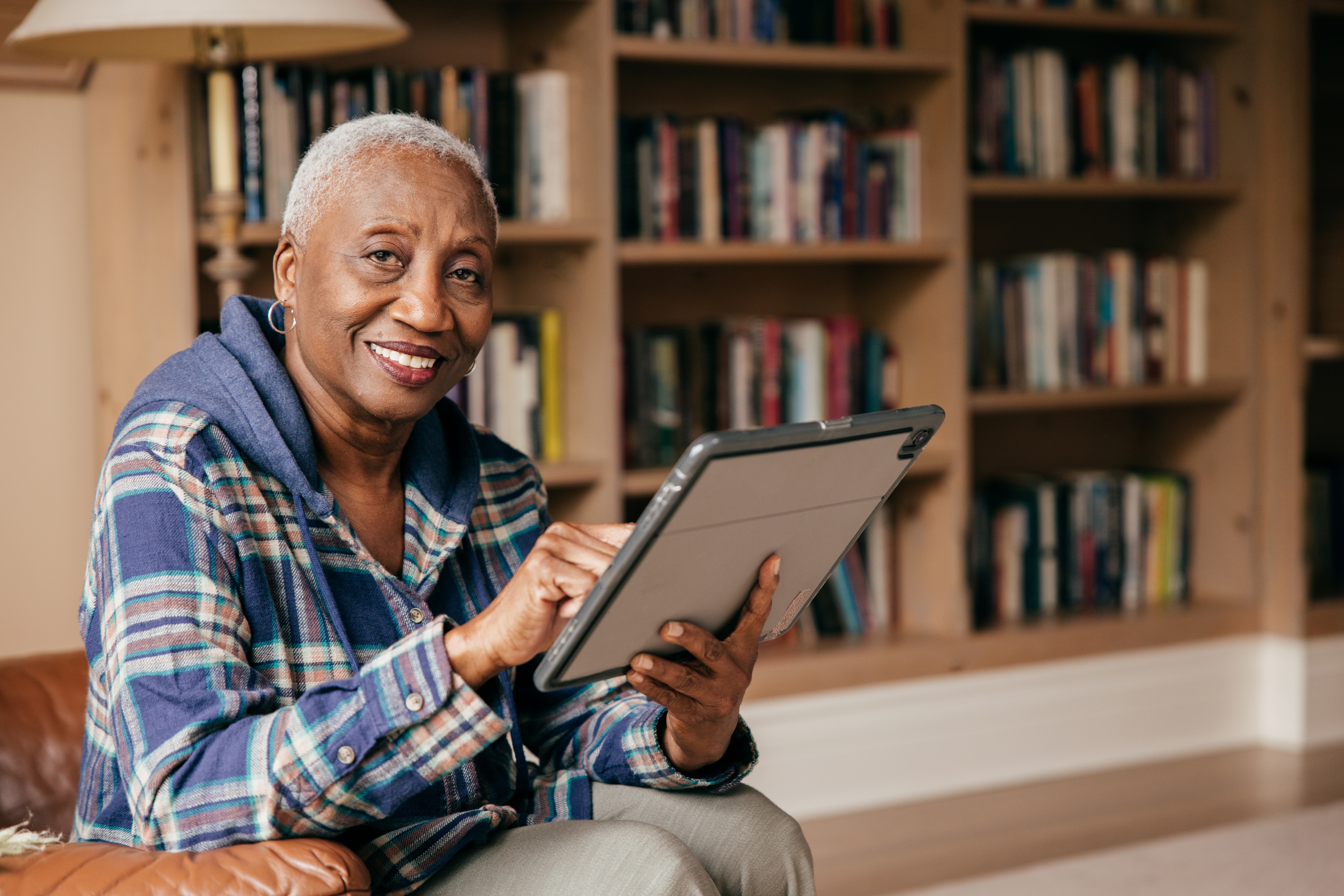 Senior Woman Using Tablet in Library