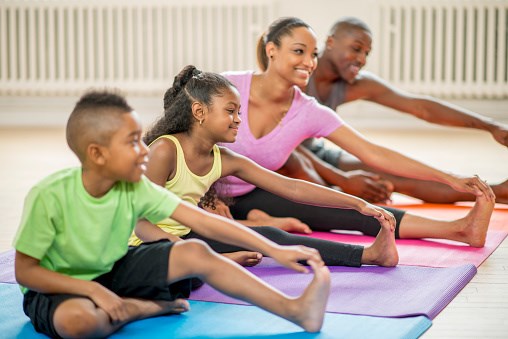 family of four doing yoga family of four doing yoga