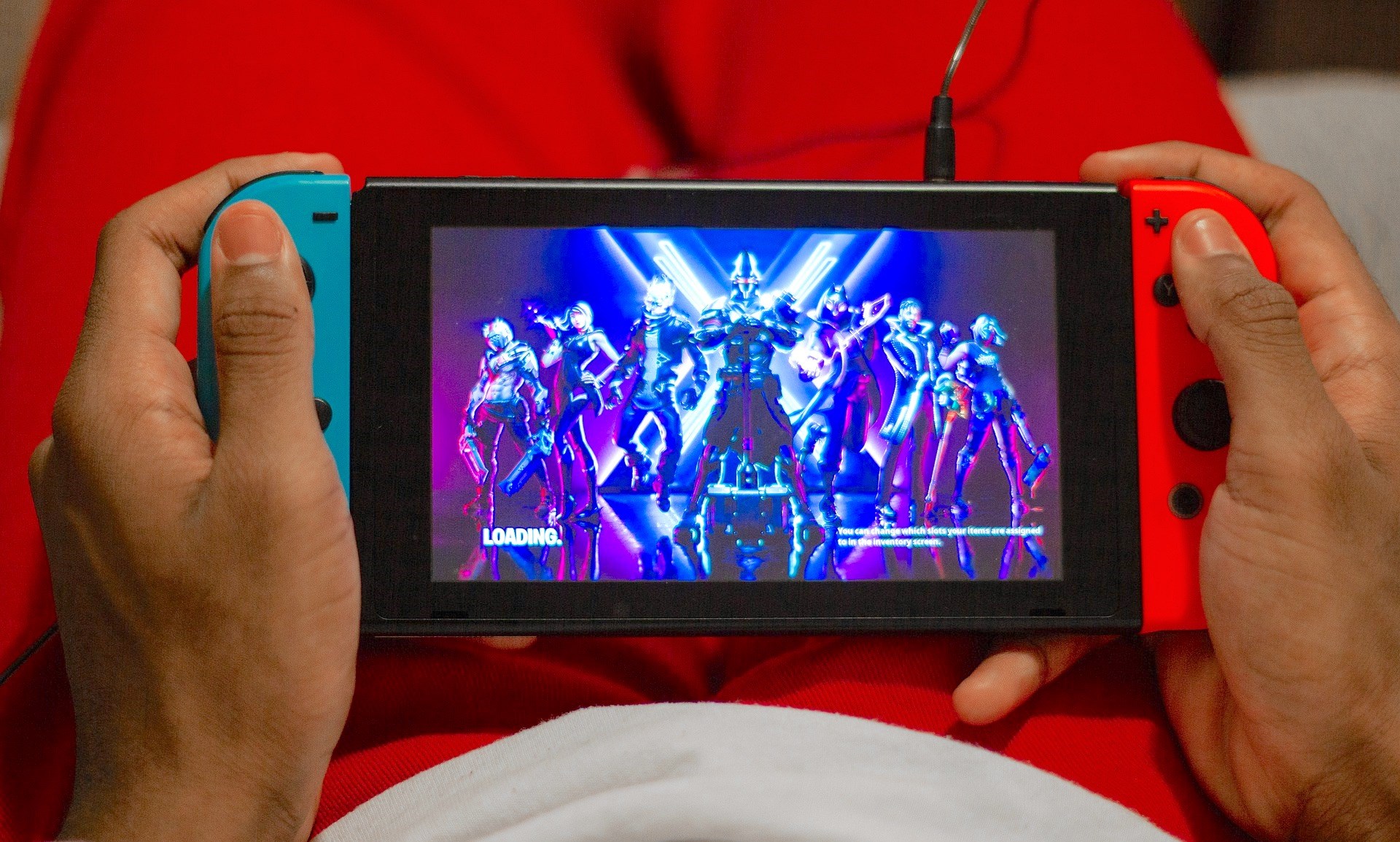teen holding a game controller teen holding a game controller