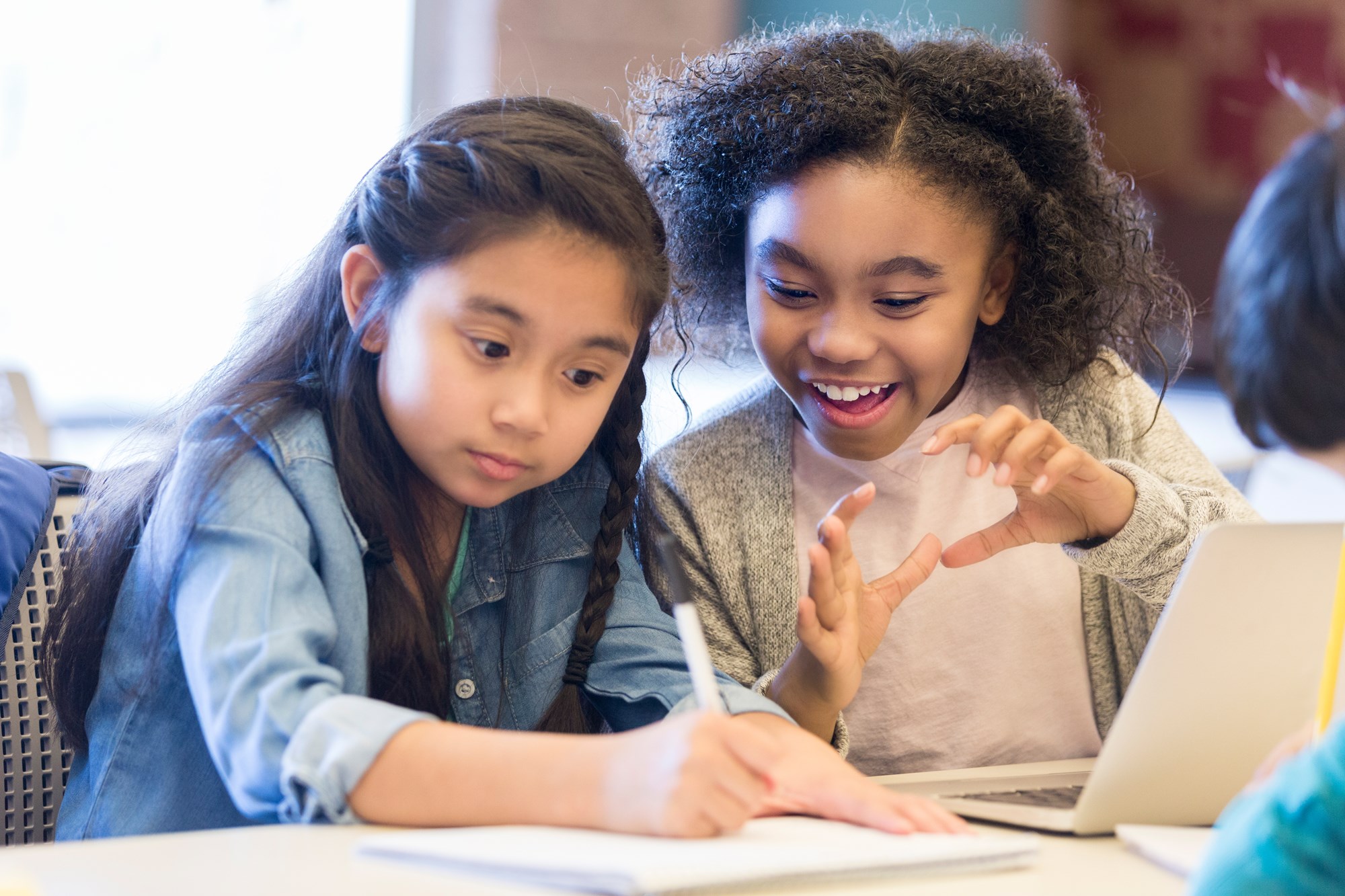 two girls at the library doing homework two girls at the library doing homework