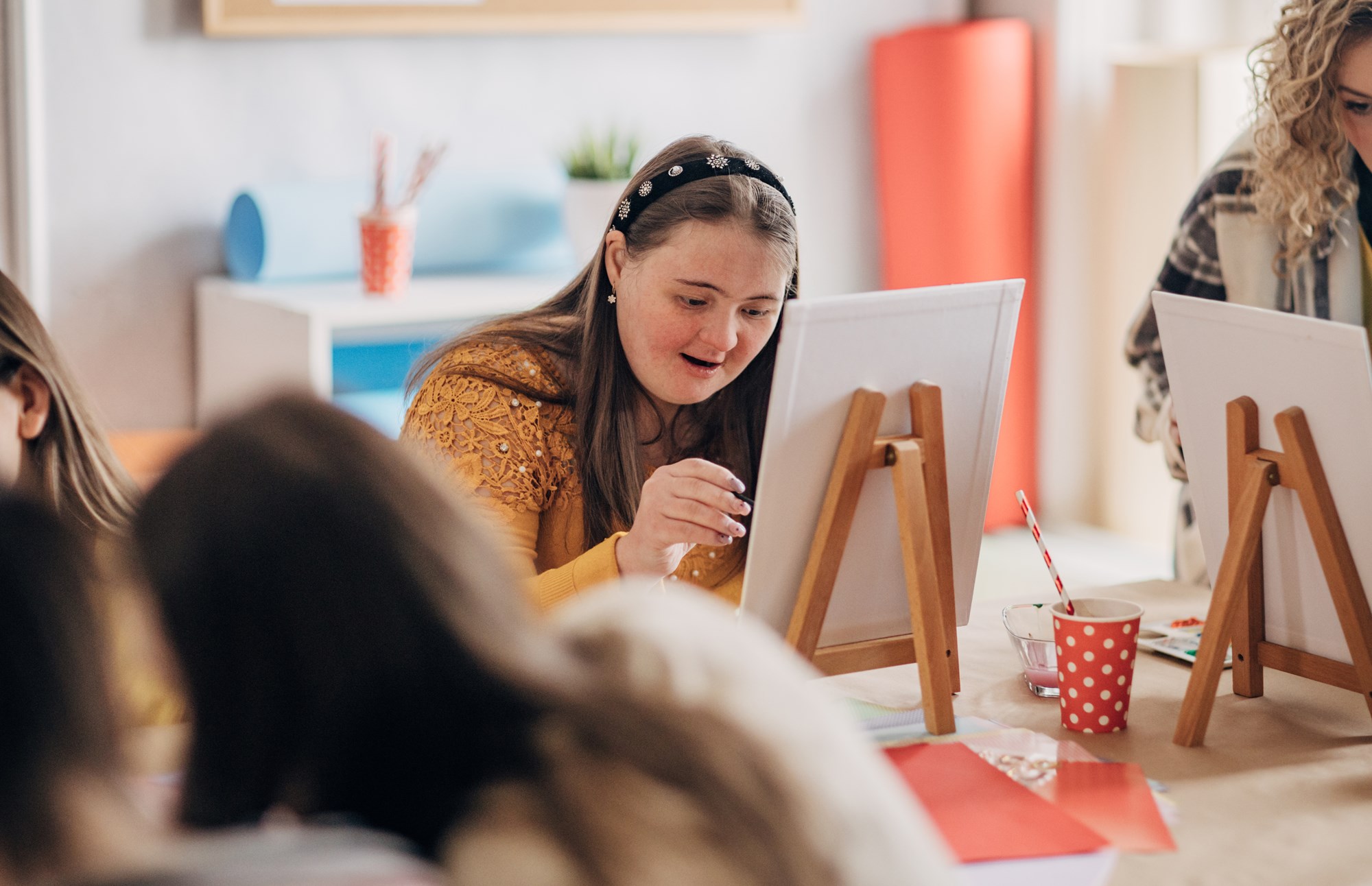teen girl painting in a room teen girl painting in a room