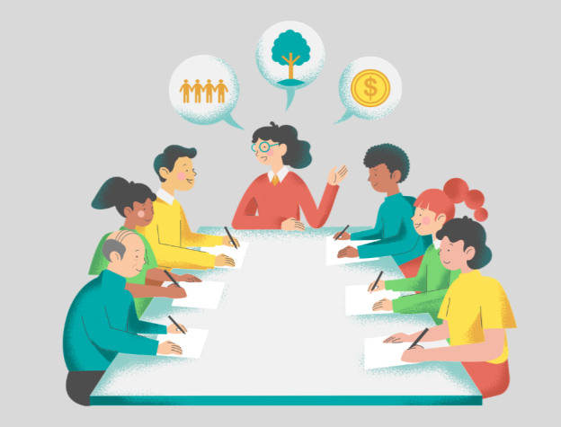 Image of a group sitting around a table listening to a speaker