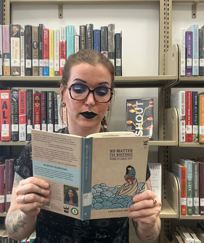 Library staff holding No Matter The Wreckage