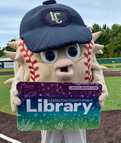 Blowie the Blowfish baseball mascot holding a LexCoLibrary card