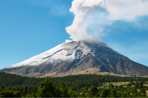 Volcano with white smoke coming out of the top.