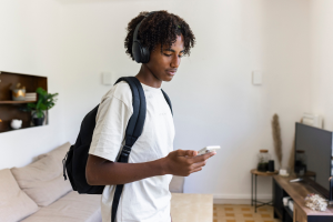 Teen listening using headphones