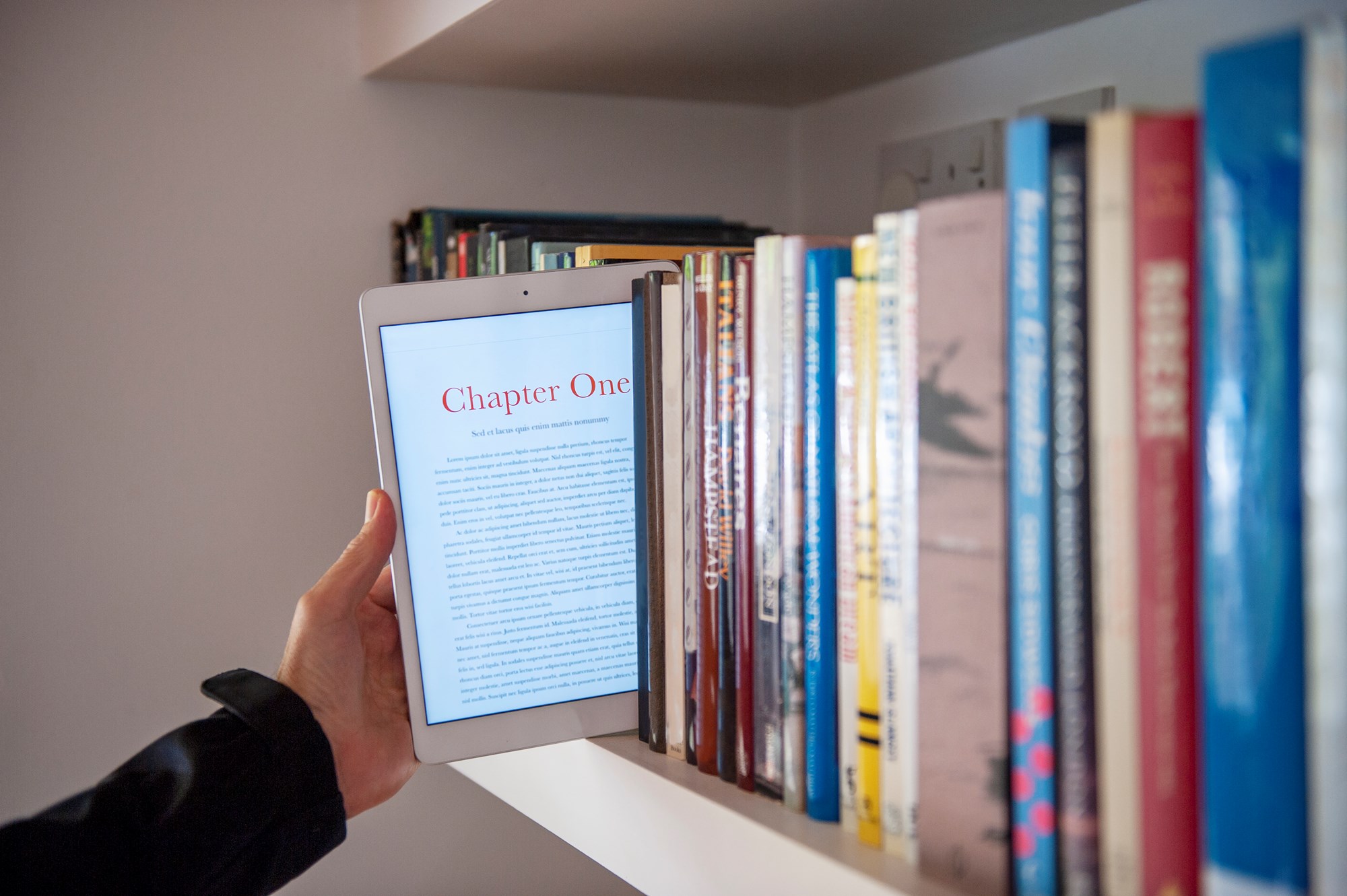Tablet E-Book Being Taken from Bookcase