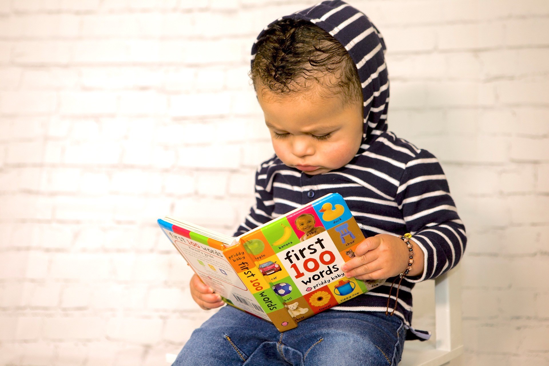 Toddler Looking at a Book