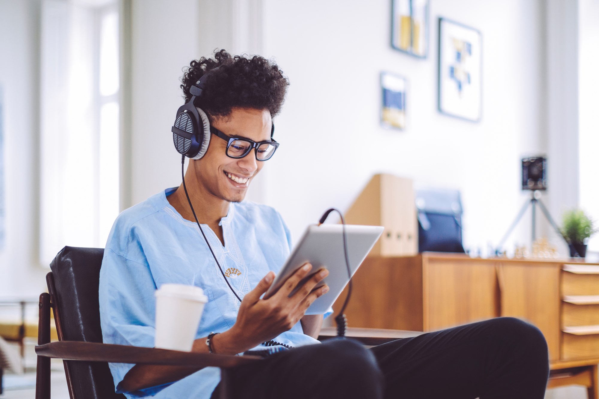 Young Man Using Tablet and Wearing Headphones.jpeg