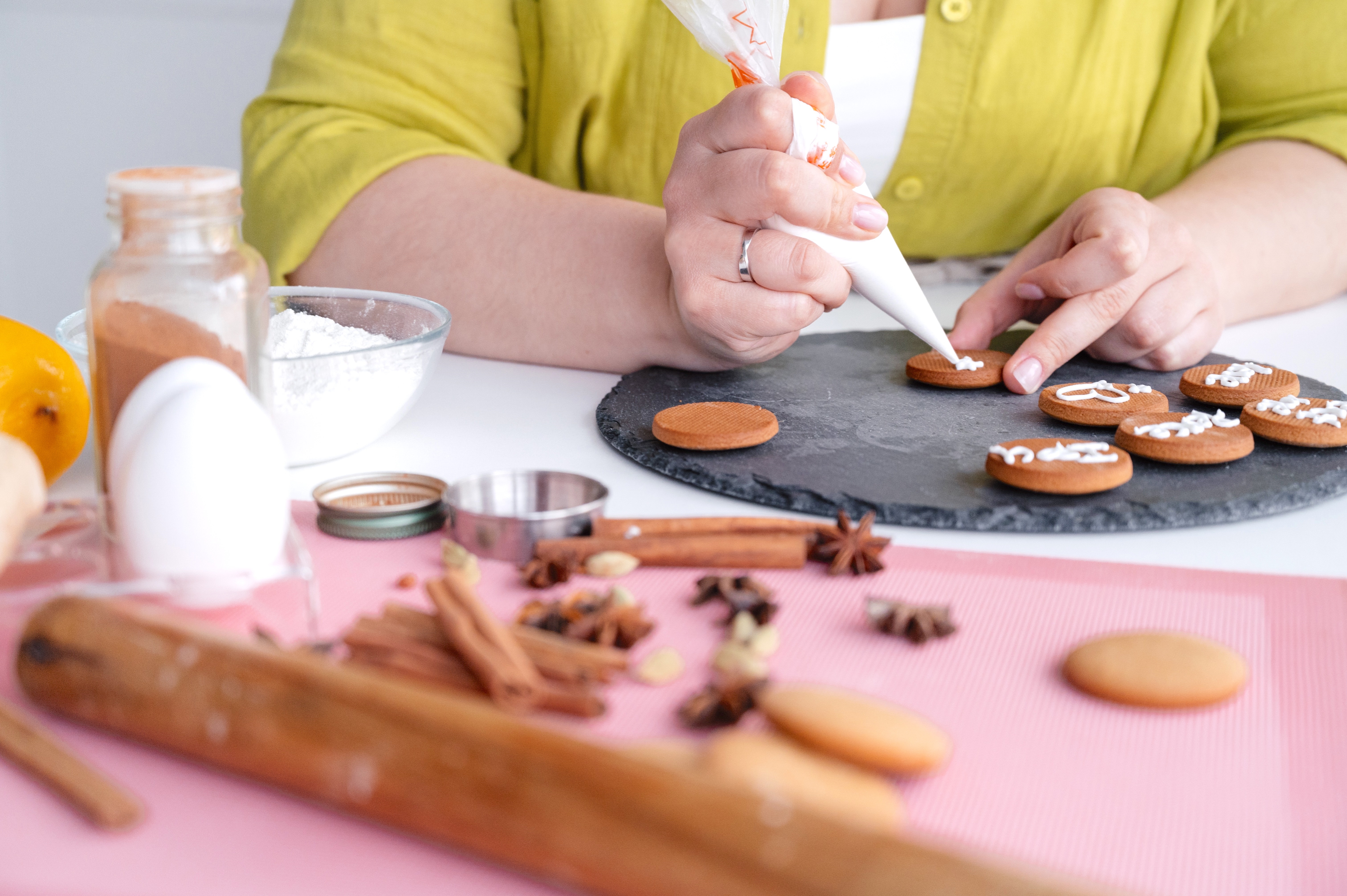 Person Decorating Gingerbread Cookies