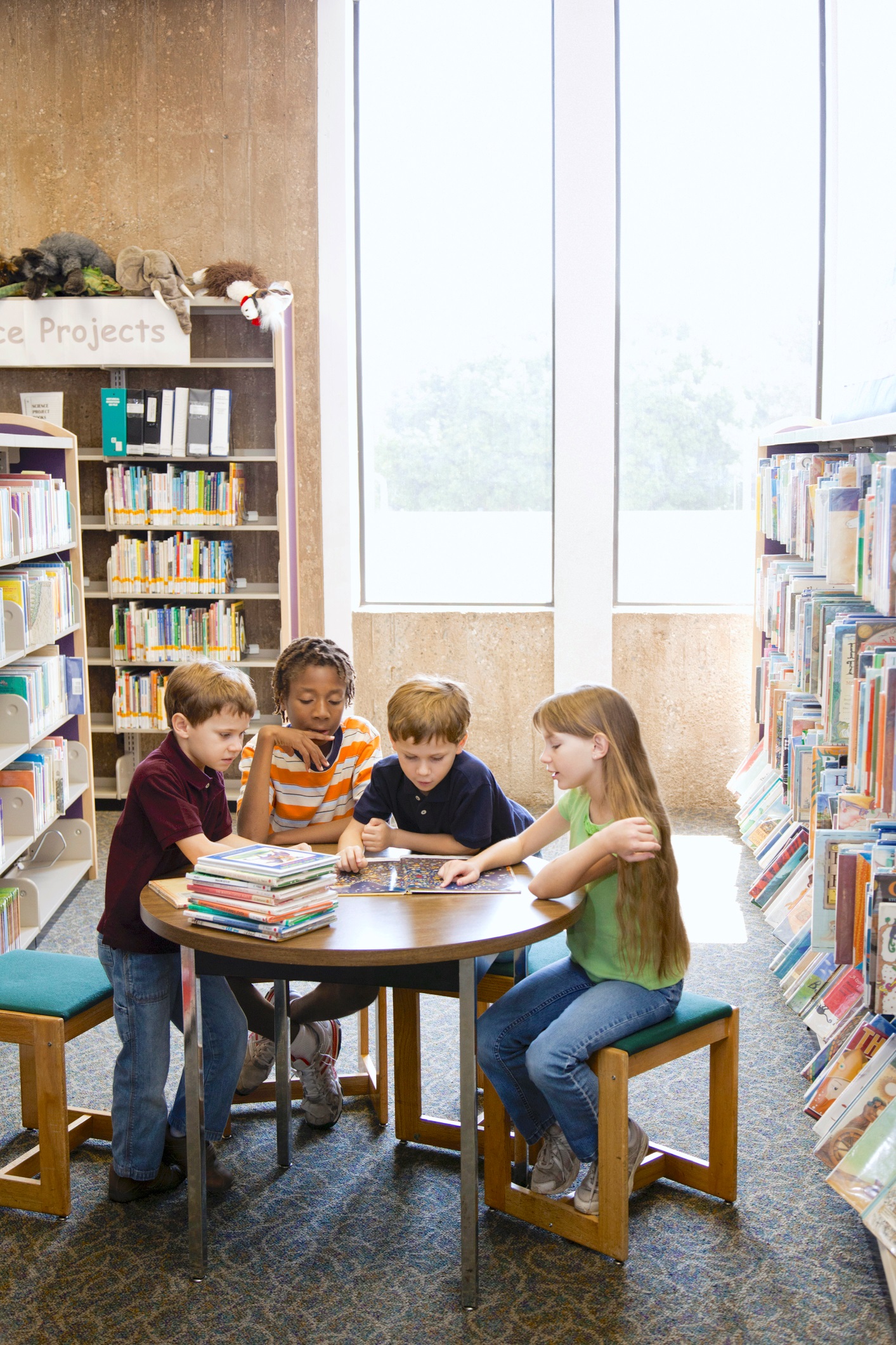 Children Reading a Book Together in the Library