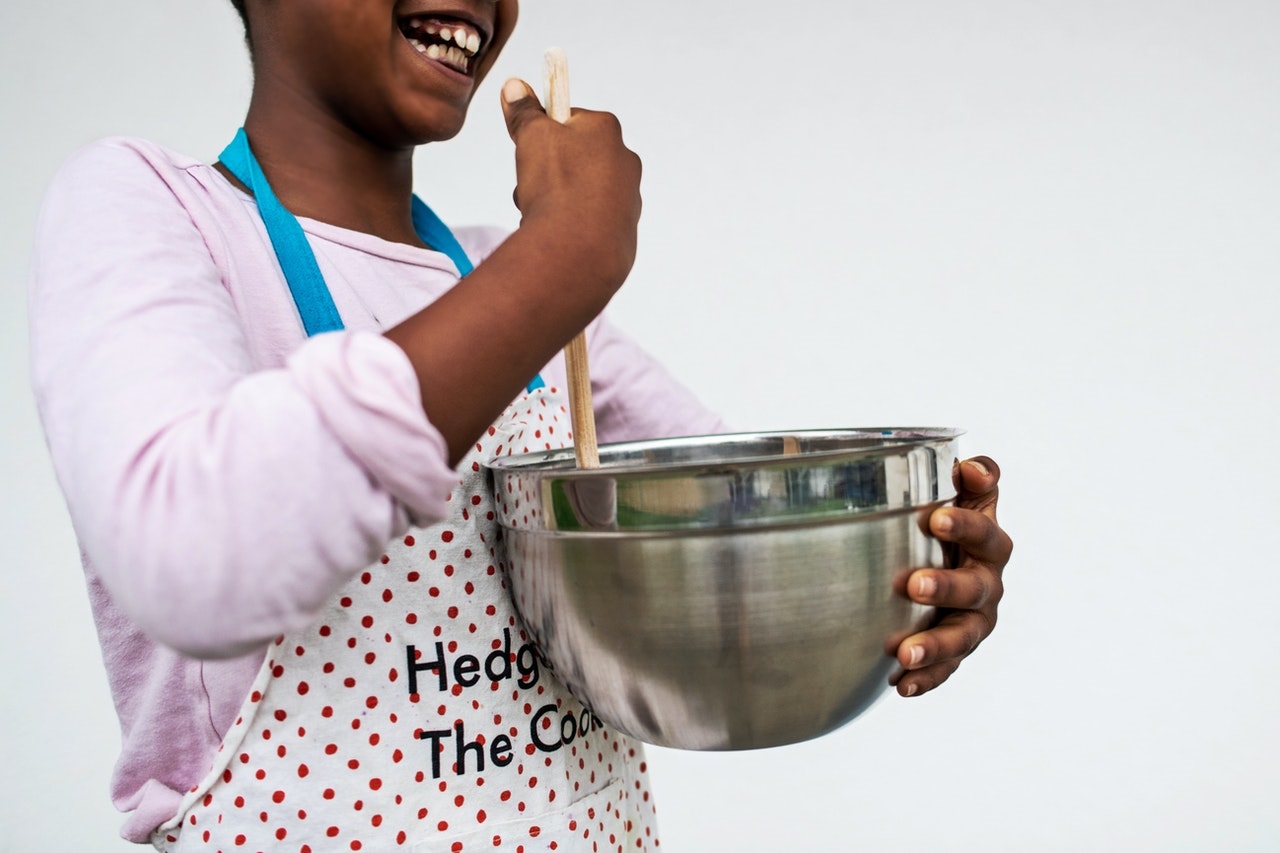 Teen Girl Holding Kitchen Utensil While Preparing Food