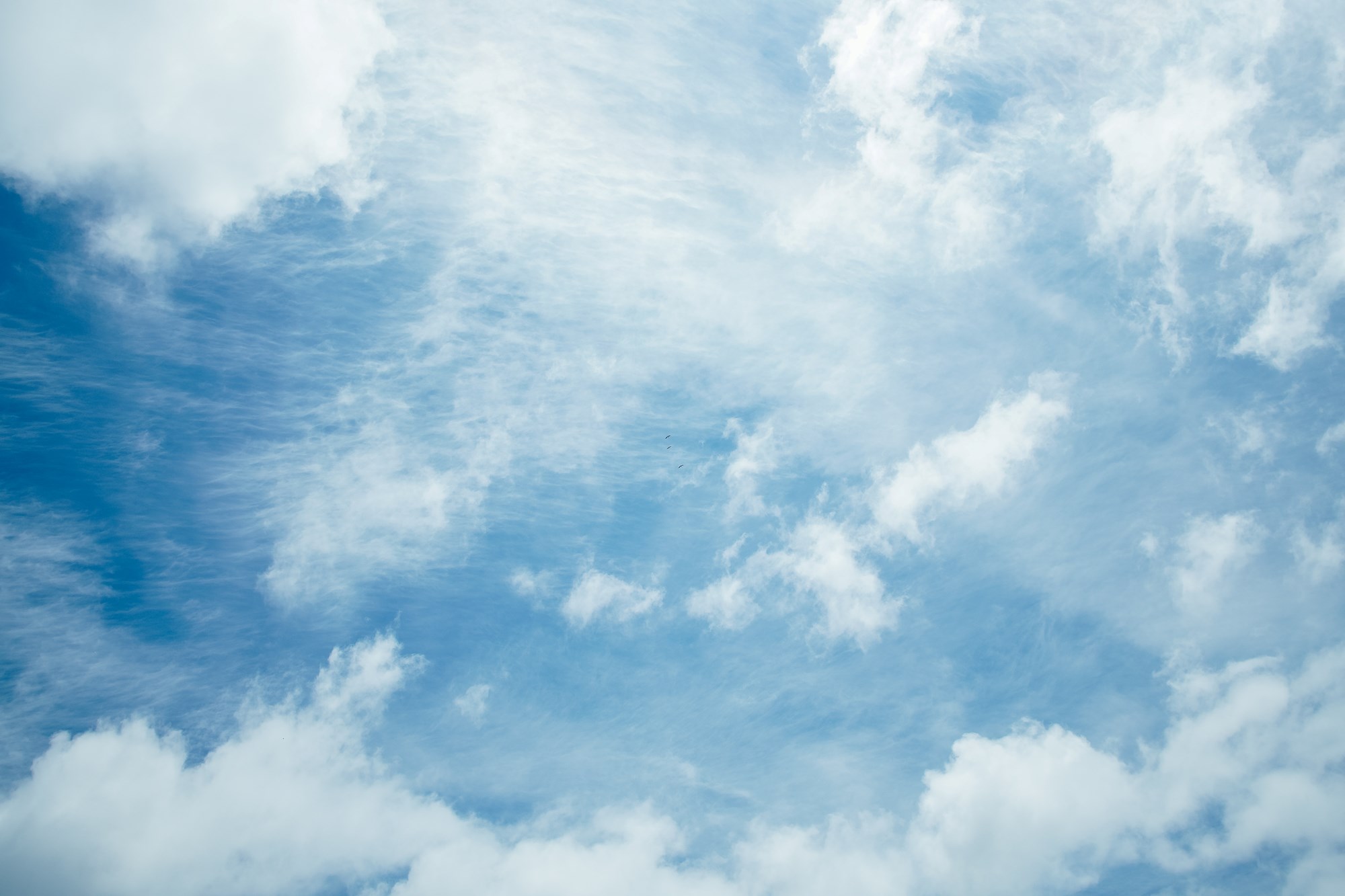 White Clouds on Blue Sky Background