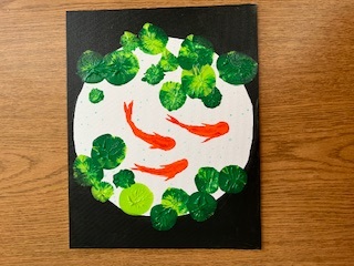 canvas of orange koi with green lily pads in a white circle