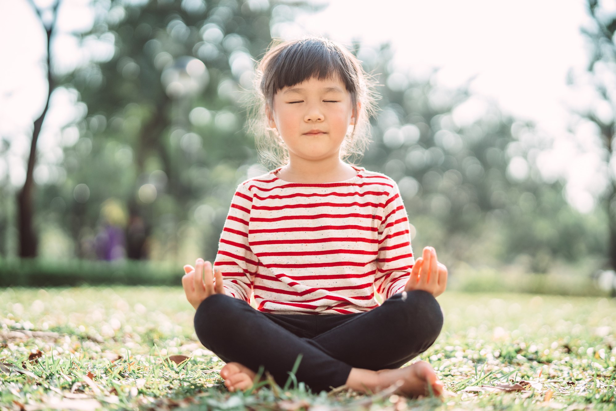 Child Practicing Yoga on the Grass Outdoors