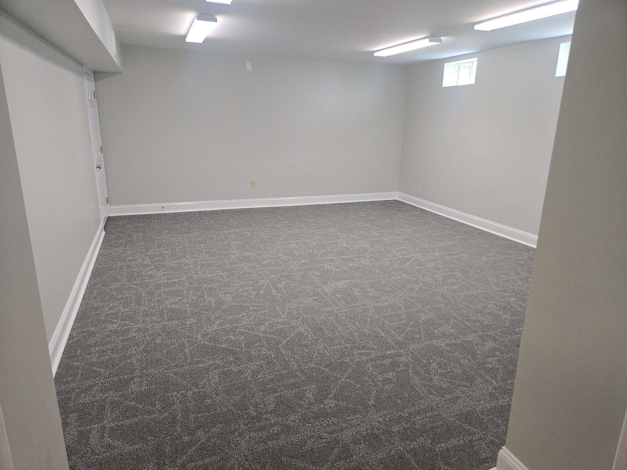 new teen room, currently empty with grey carpet and freshly painted walls
