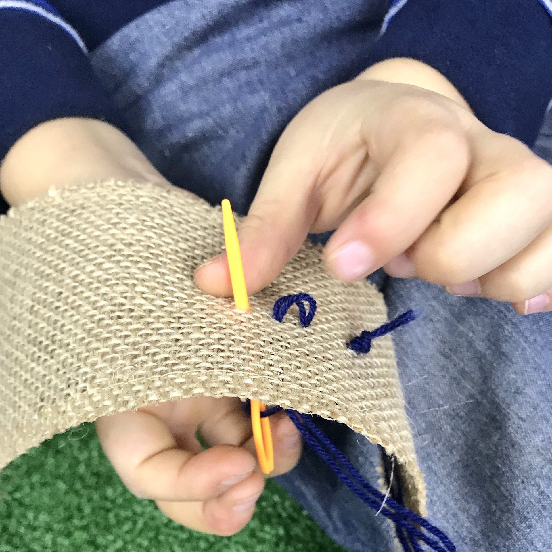 Close Up of Kid Stitching a Craft