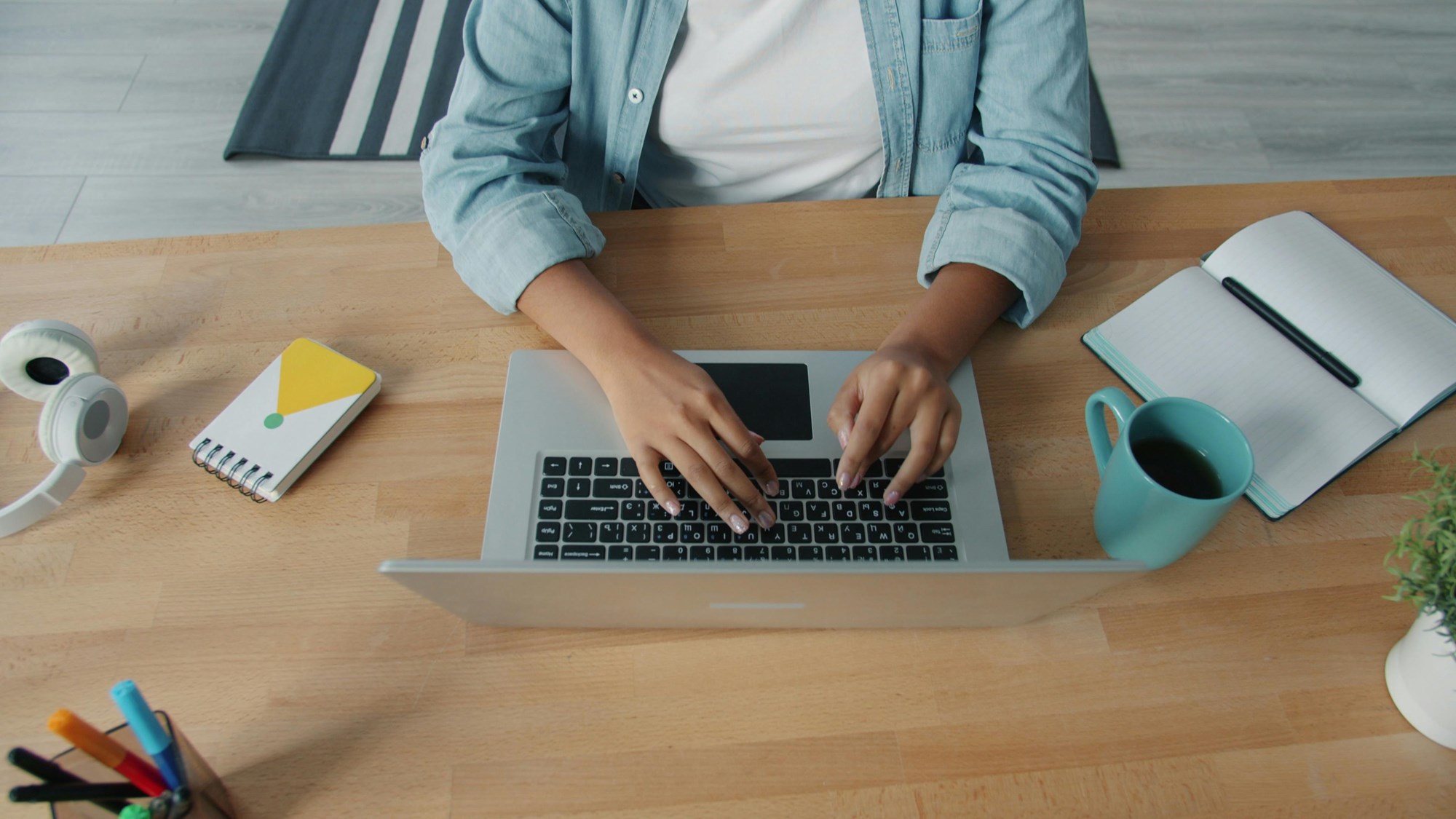 Top View of Person Working on Laptop at Desk