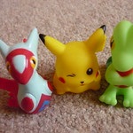3 Pokemon characters sitting on a rug