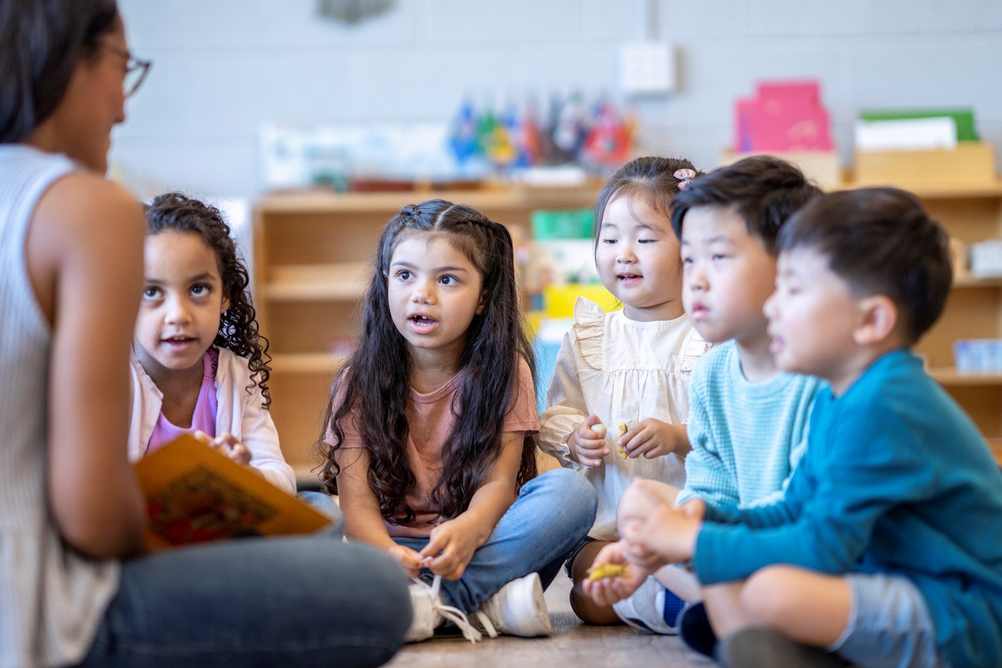 Librarian Reading a Book to Group of Young Kids