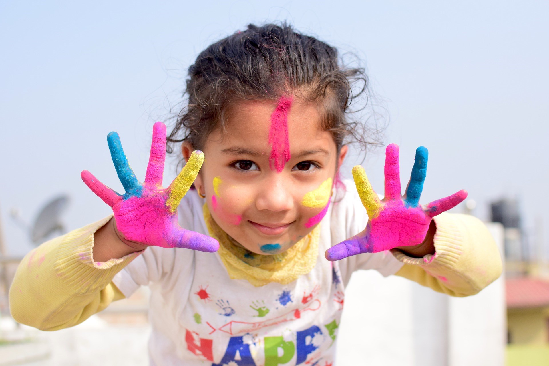 Little Girl Showing her Colored Hands to the Camera