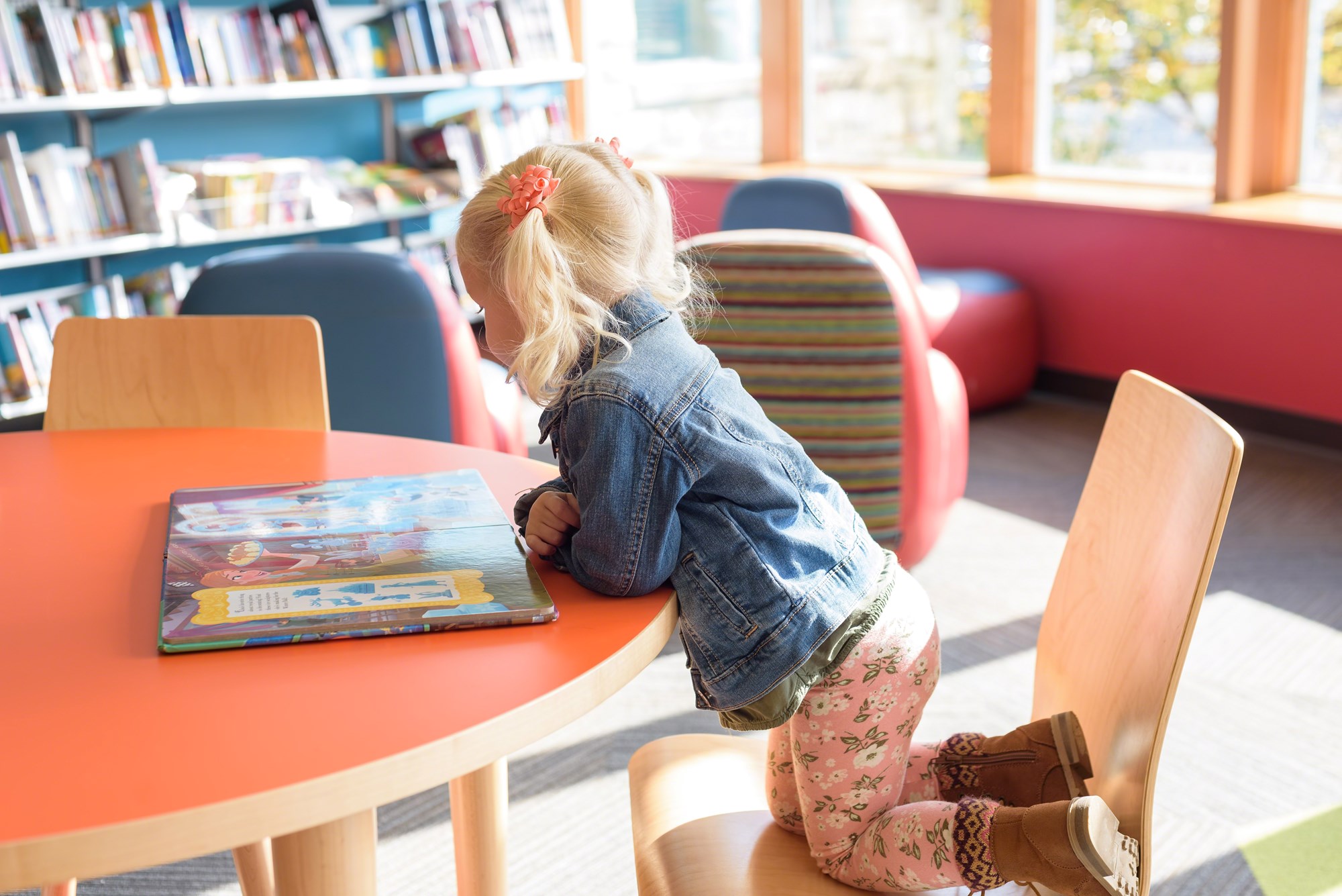 girl reading book in library