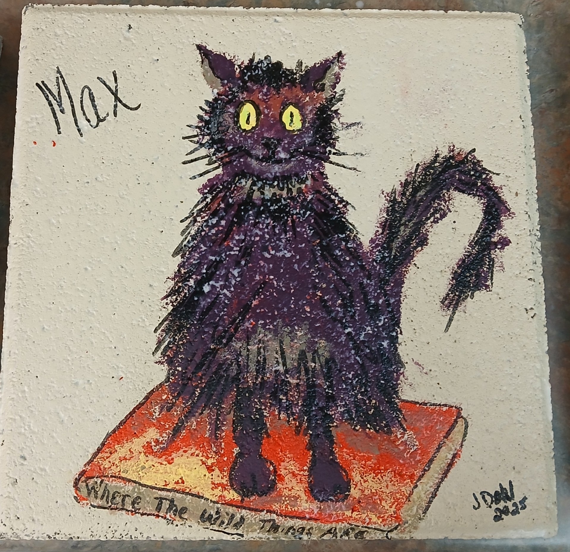 Tile painted with a picture of a black cat.