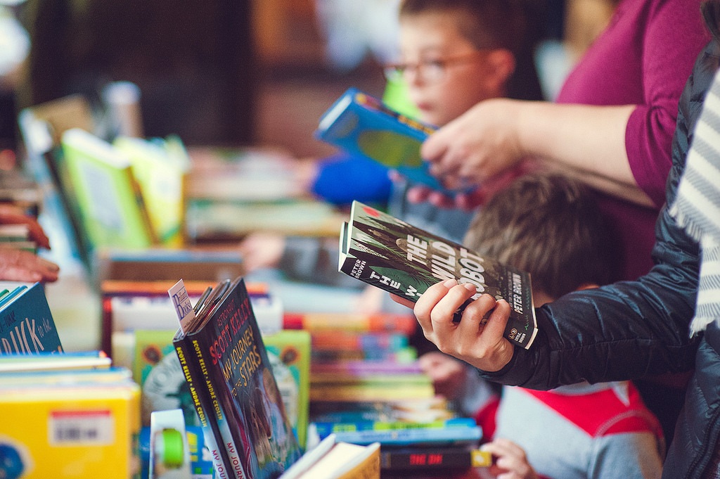 People looking through books at a book sale