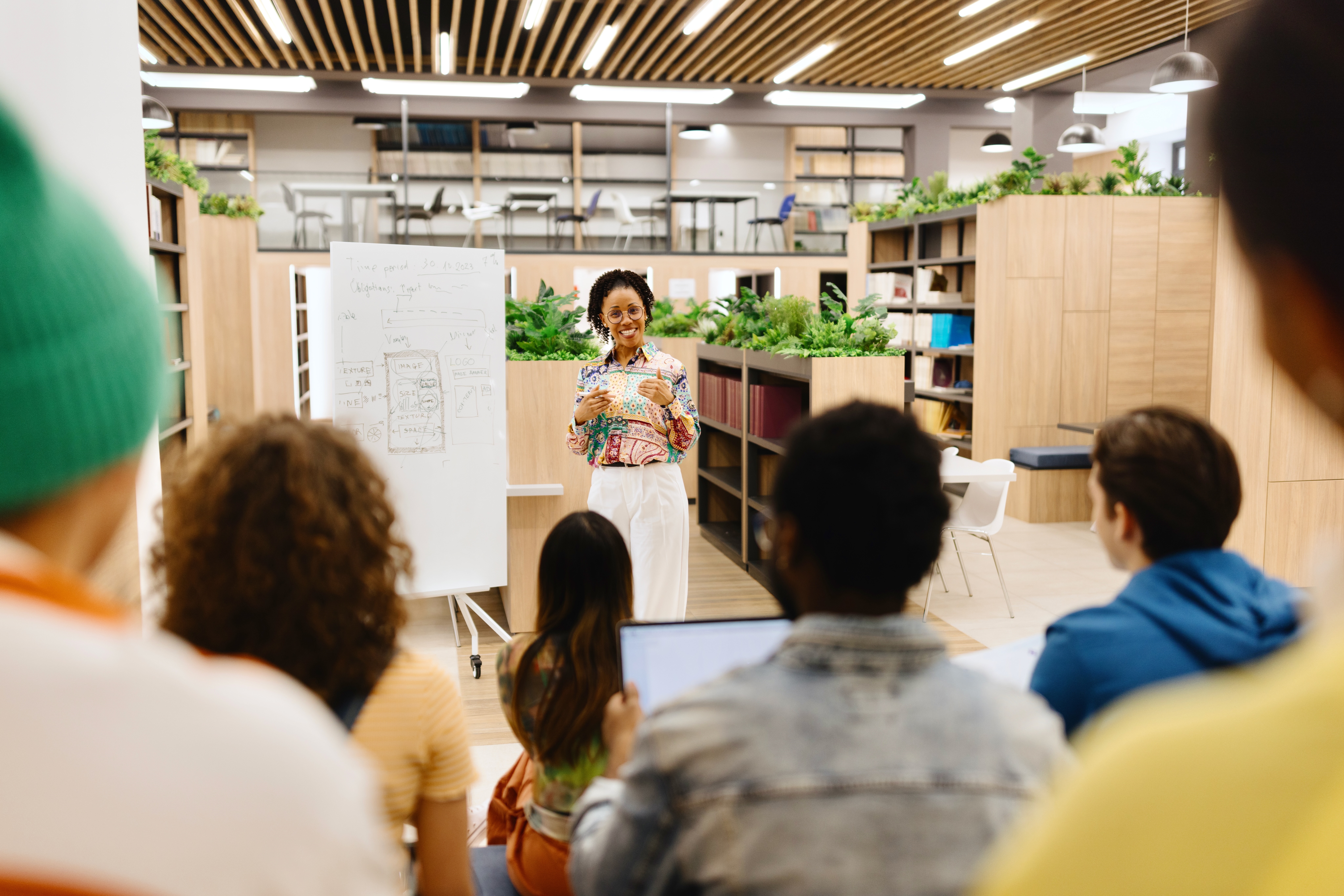 A Woman Professor Delivering a Lecture to Her Students in The Library