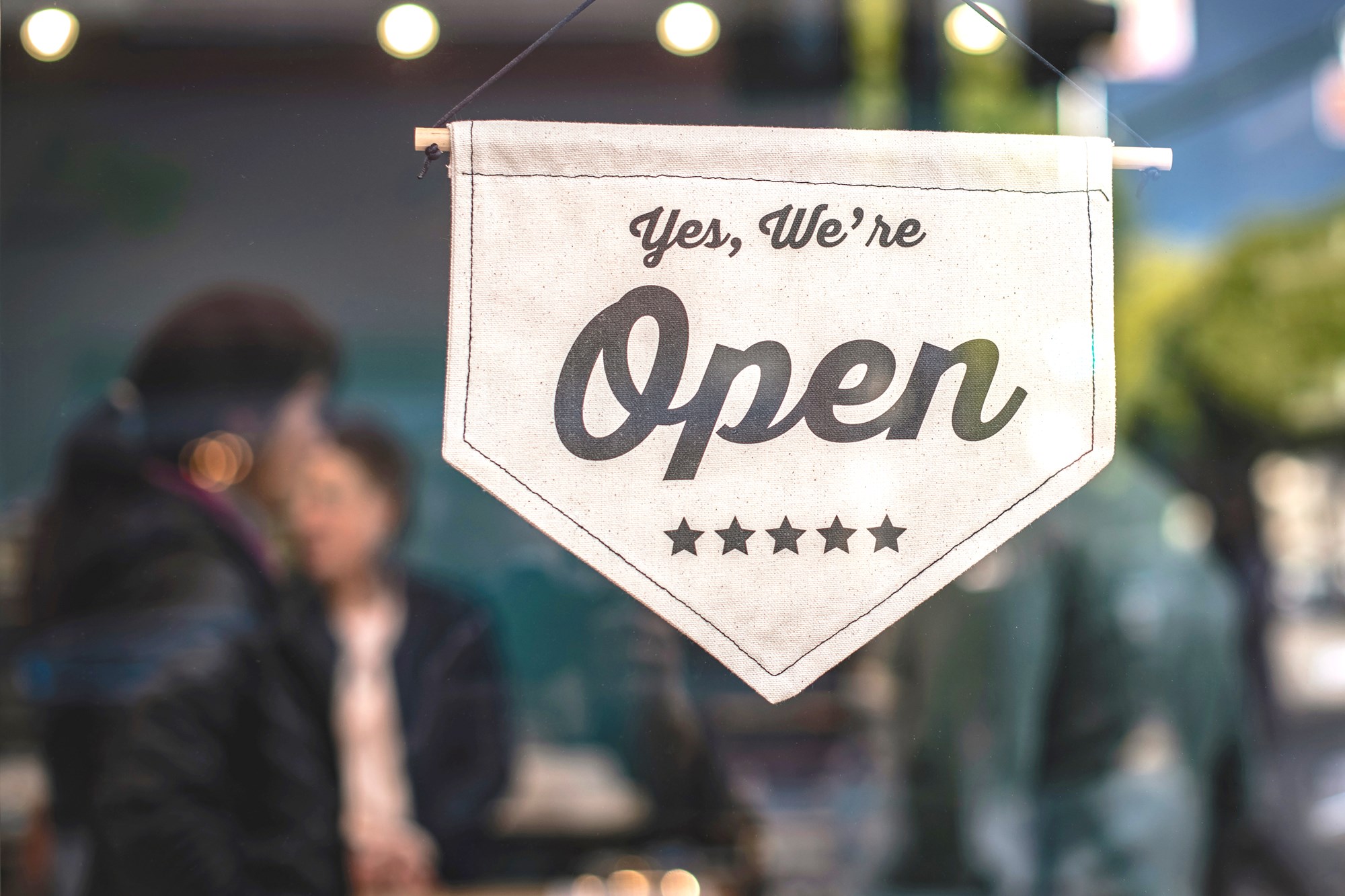 Yes We're Open Sign on Store Window