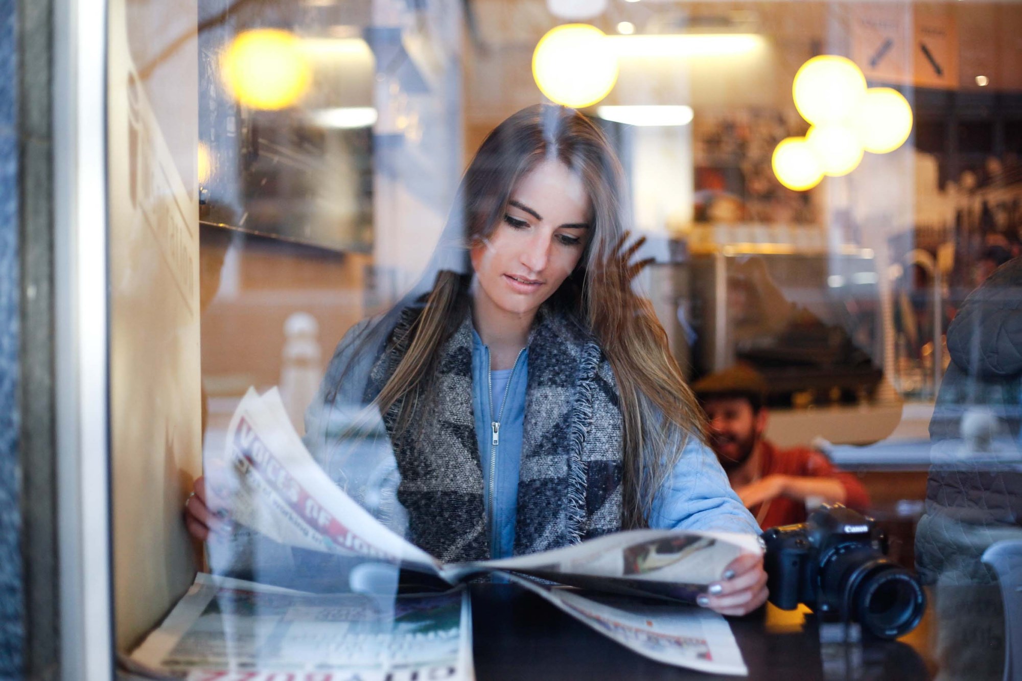 Teen Women Reading Newspaper At Cafe