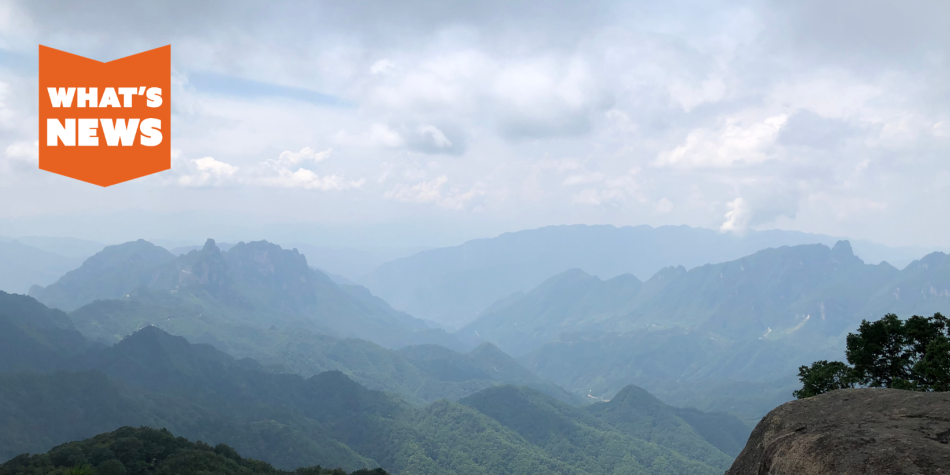 A view of clouds over the three gorges area of China with an orange "what's news" logo in the corner