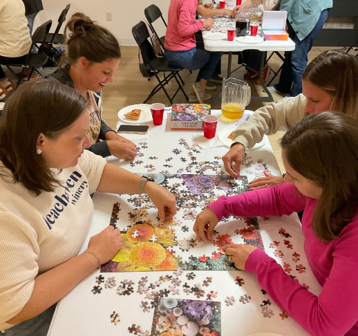 photo of 4 people working on a puzzle