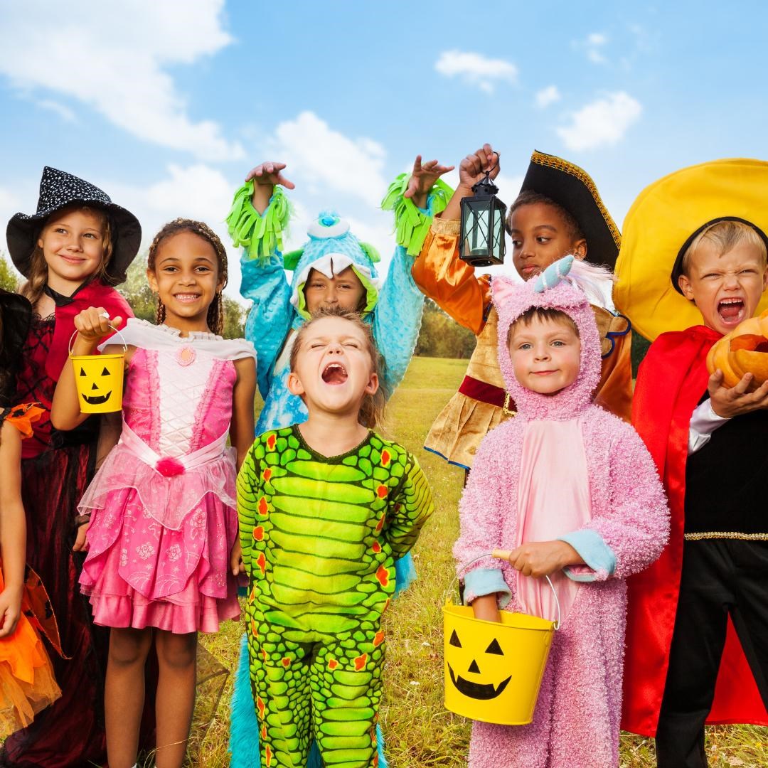 Smiling kids in assorted halloween costumes
