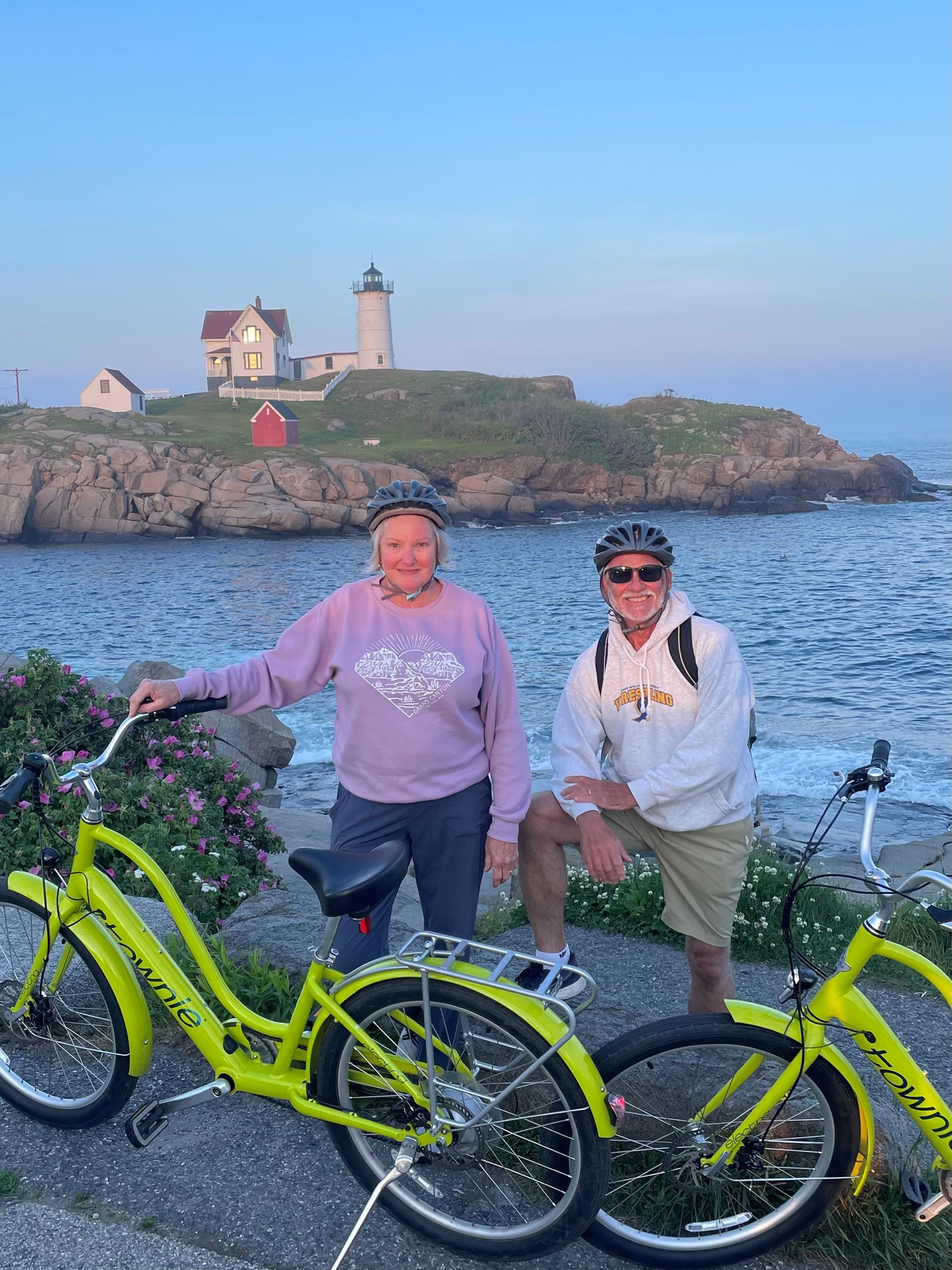 Two adults with eBikes in front of Nubble Light House