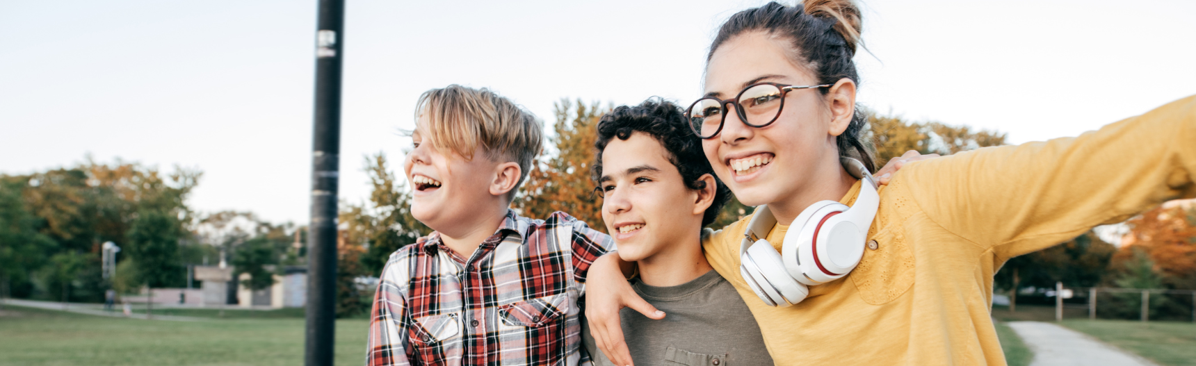 Teens and tweens walking and smiling on a fall day