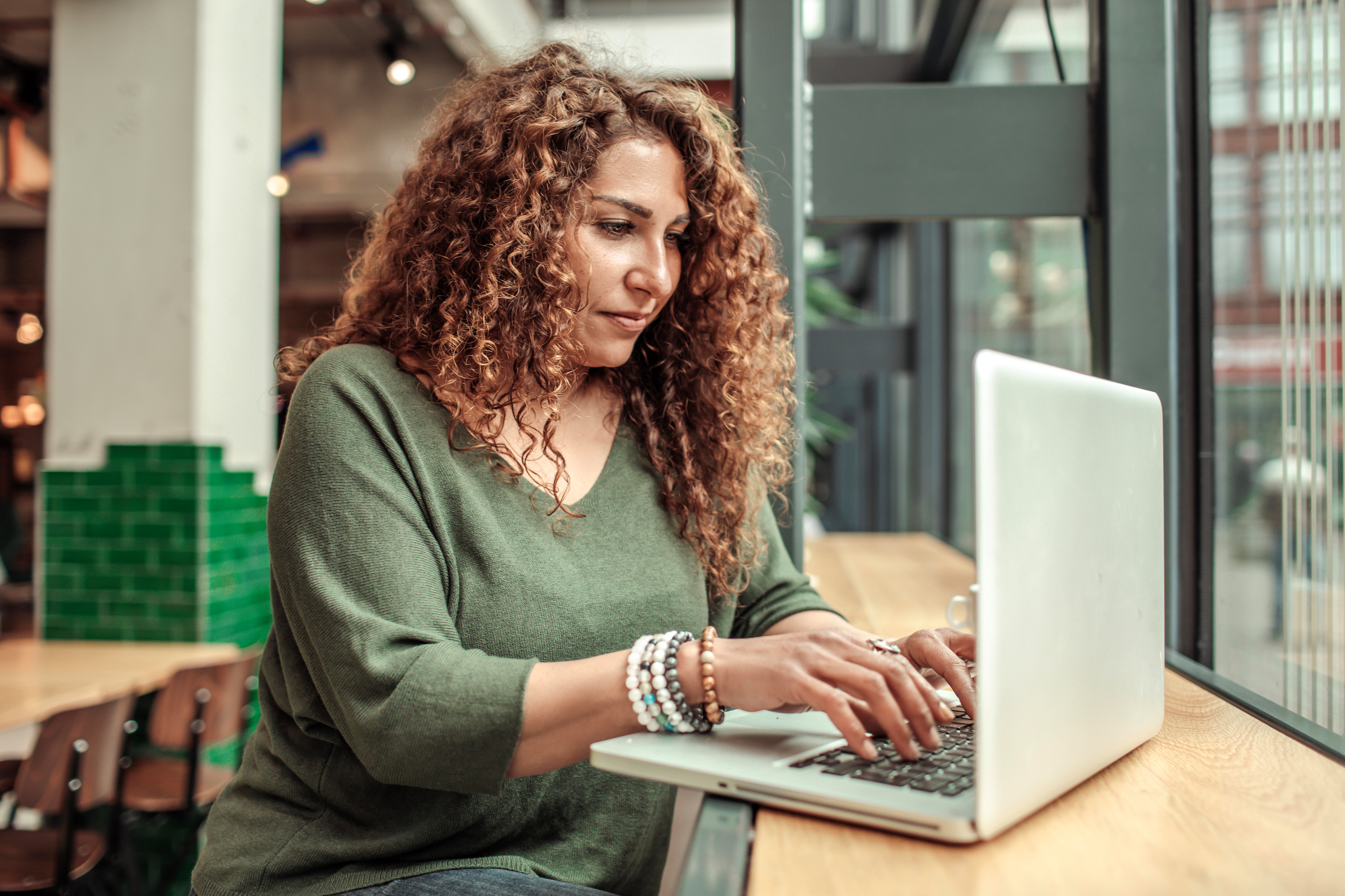 Woman Using Laptop in the Library
