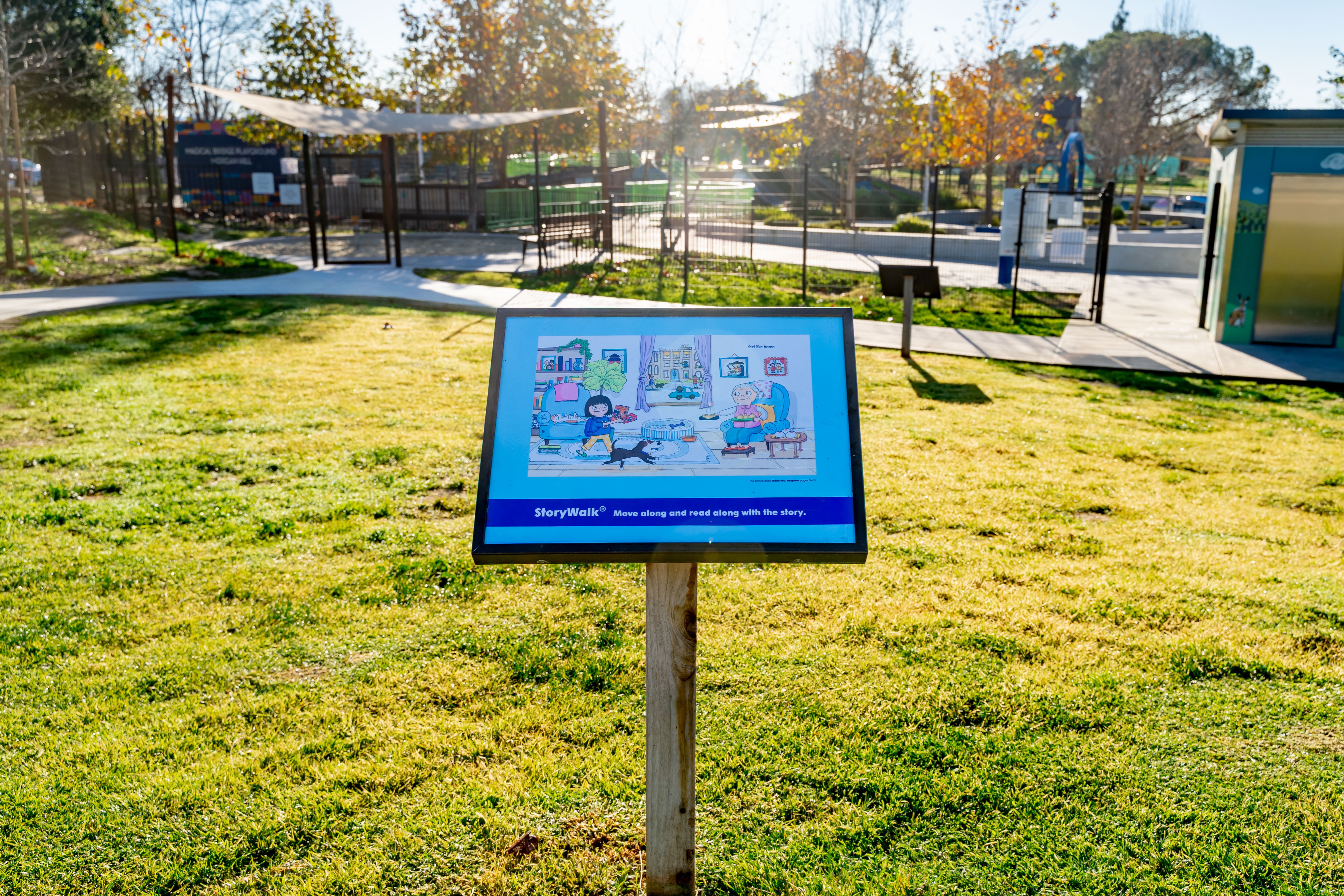 StoryWalk featuring Thank You, Neighbor by Ruth Chan in a park. 