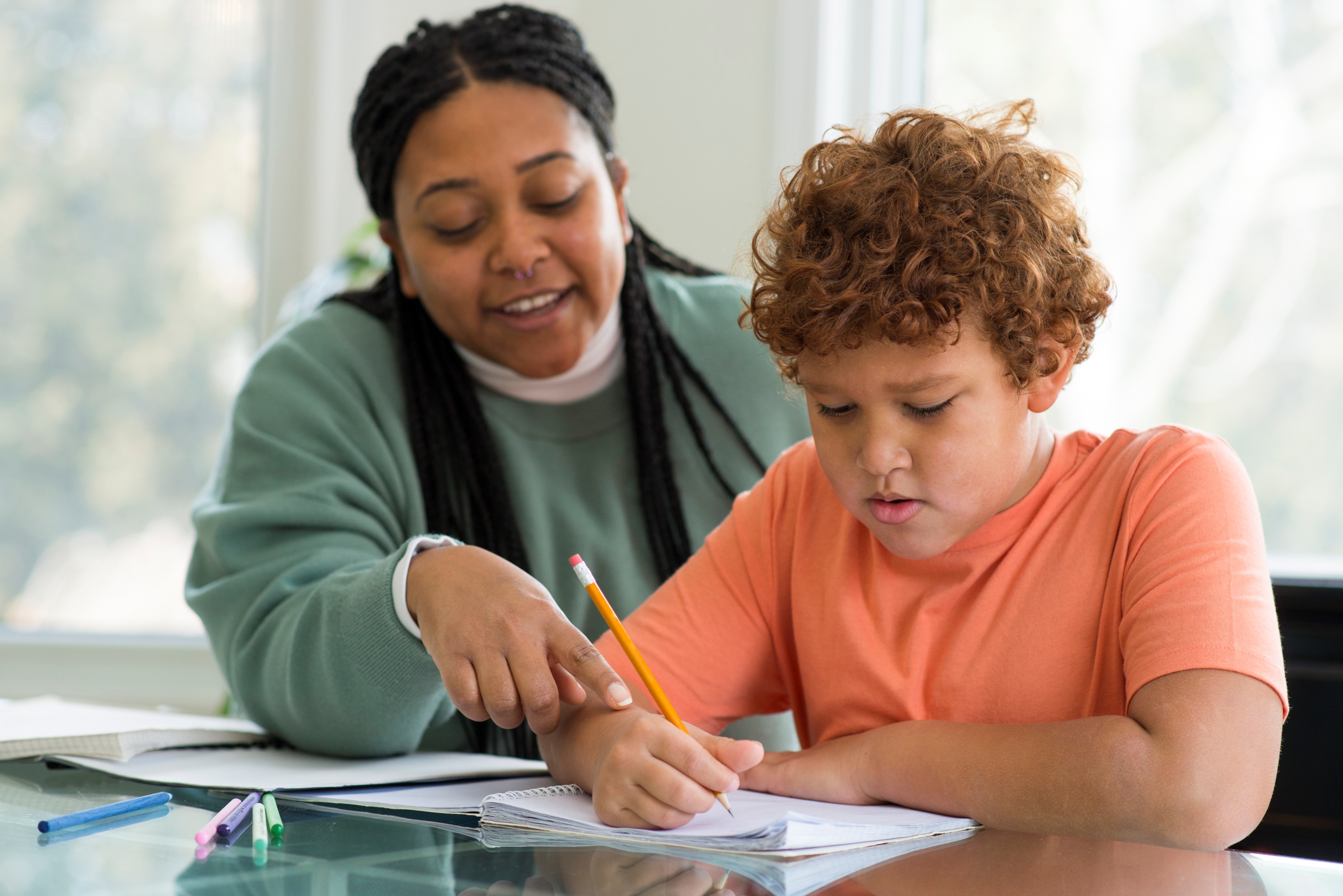 Woman Tutoring Her Son Homework