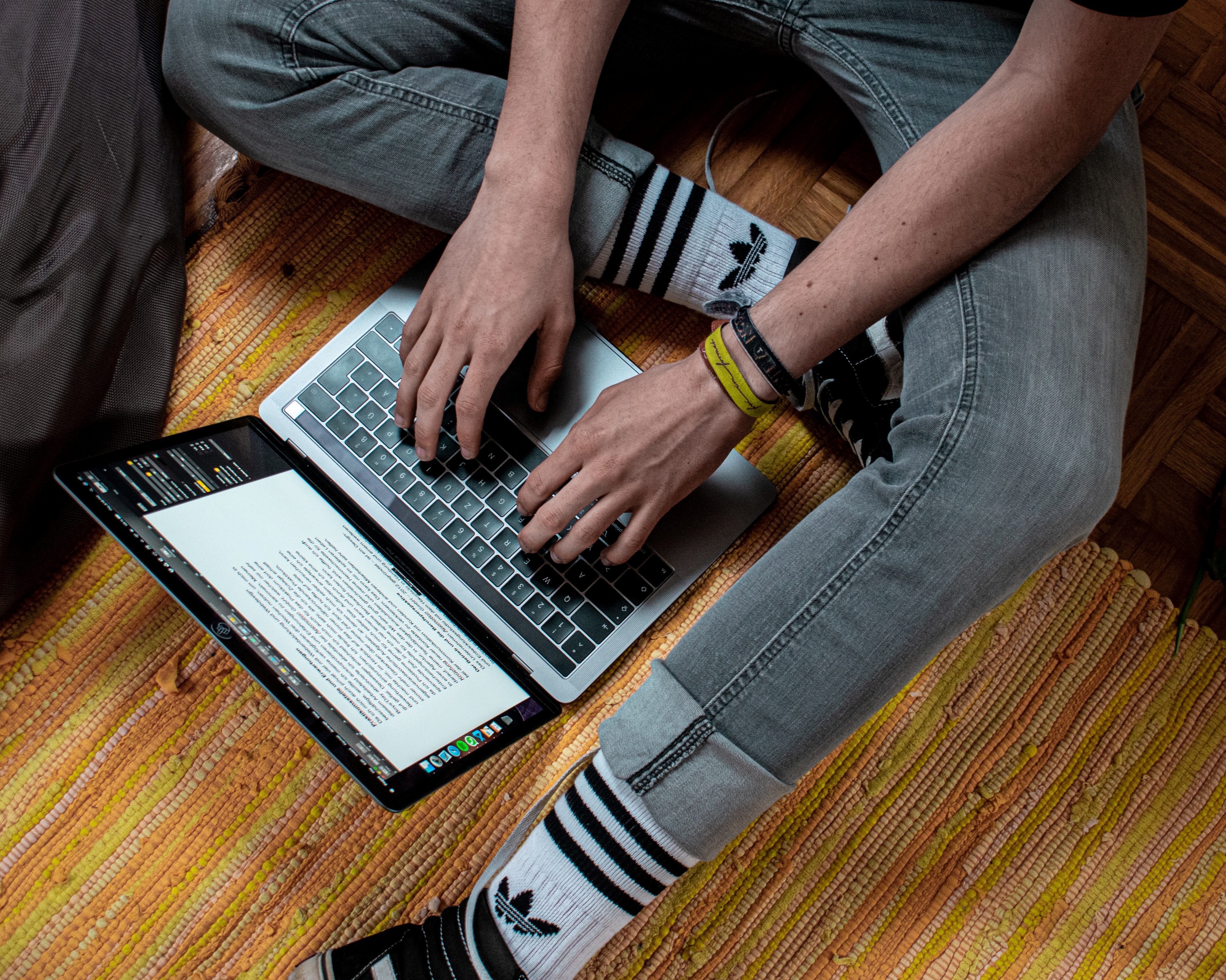 Male Teen Using a Laptop on the Floor