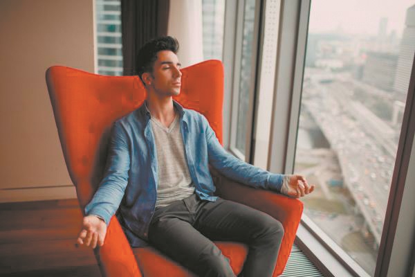 Man sitting in a chair meditating