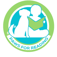 Paws for Reading Logo: Child reading book to dog
