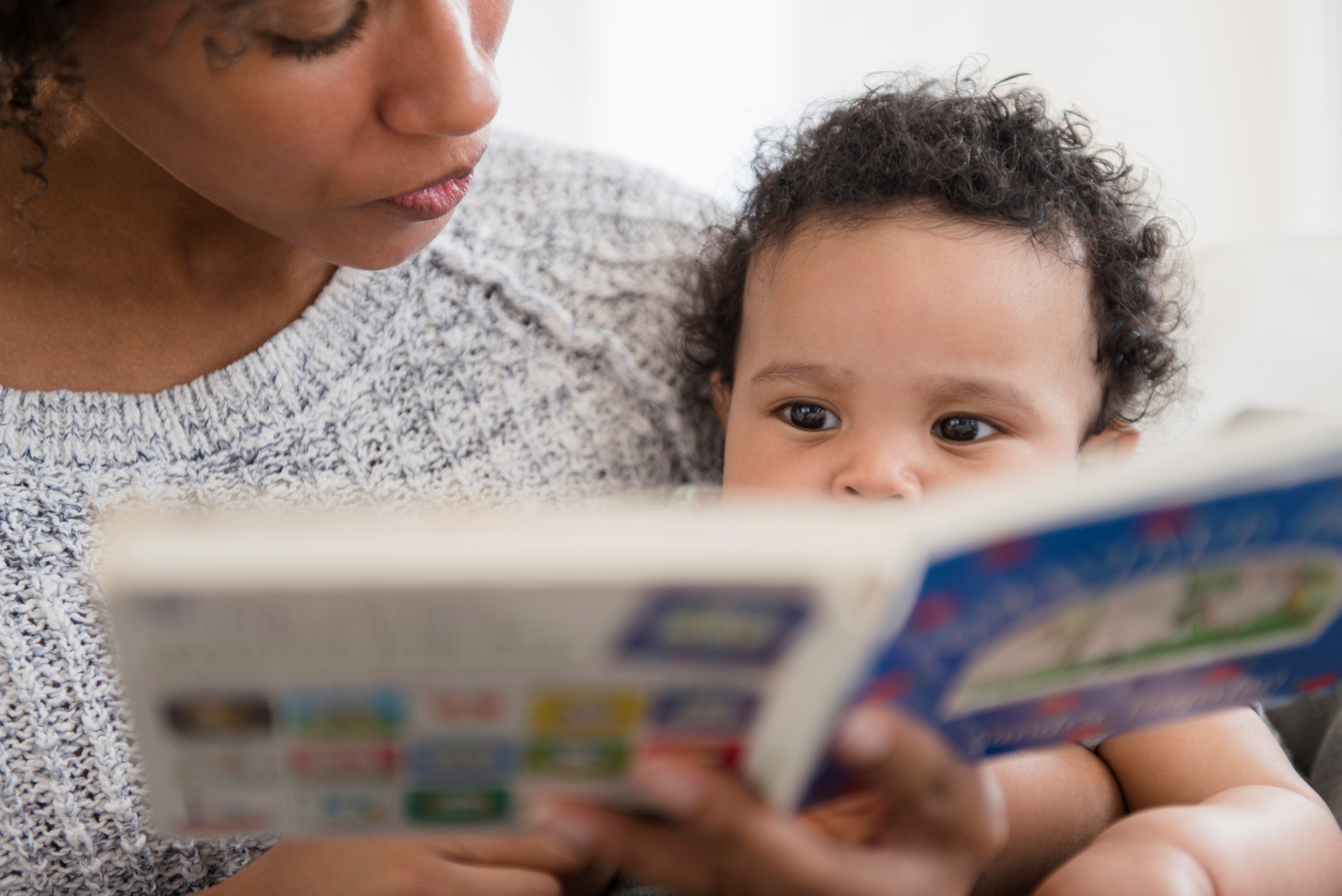 Close Up of Mother Reading Book to Baby