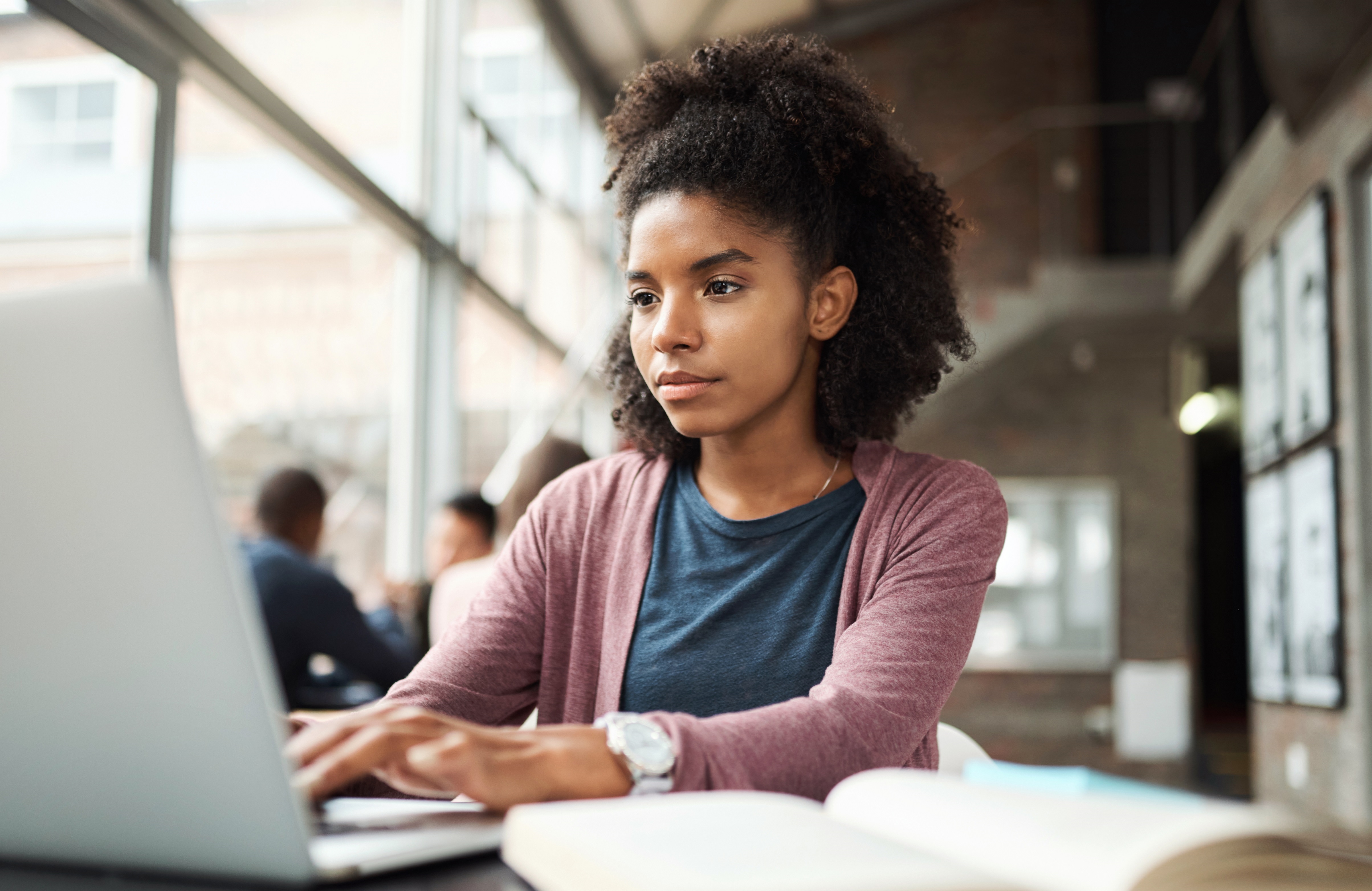 Female University Student Using Laptop and Studying