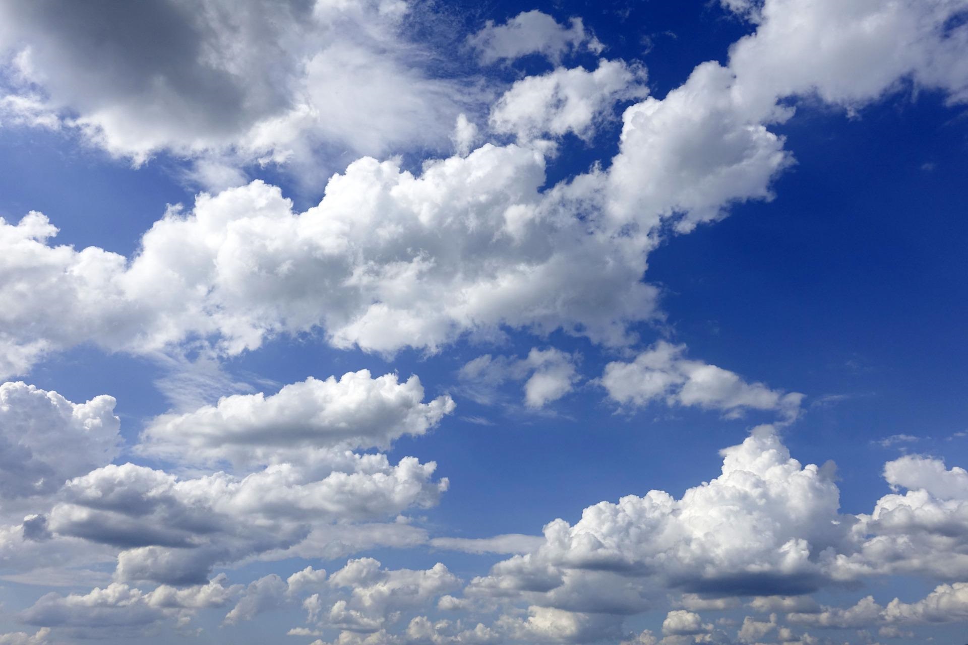 White Clouds Against Blue Sky Background