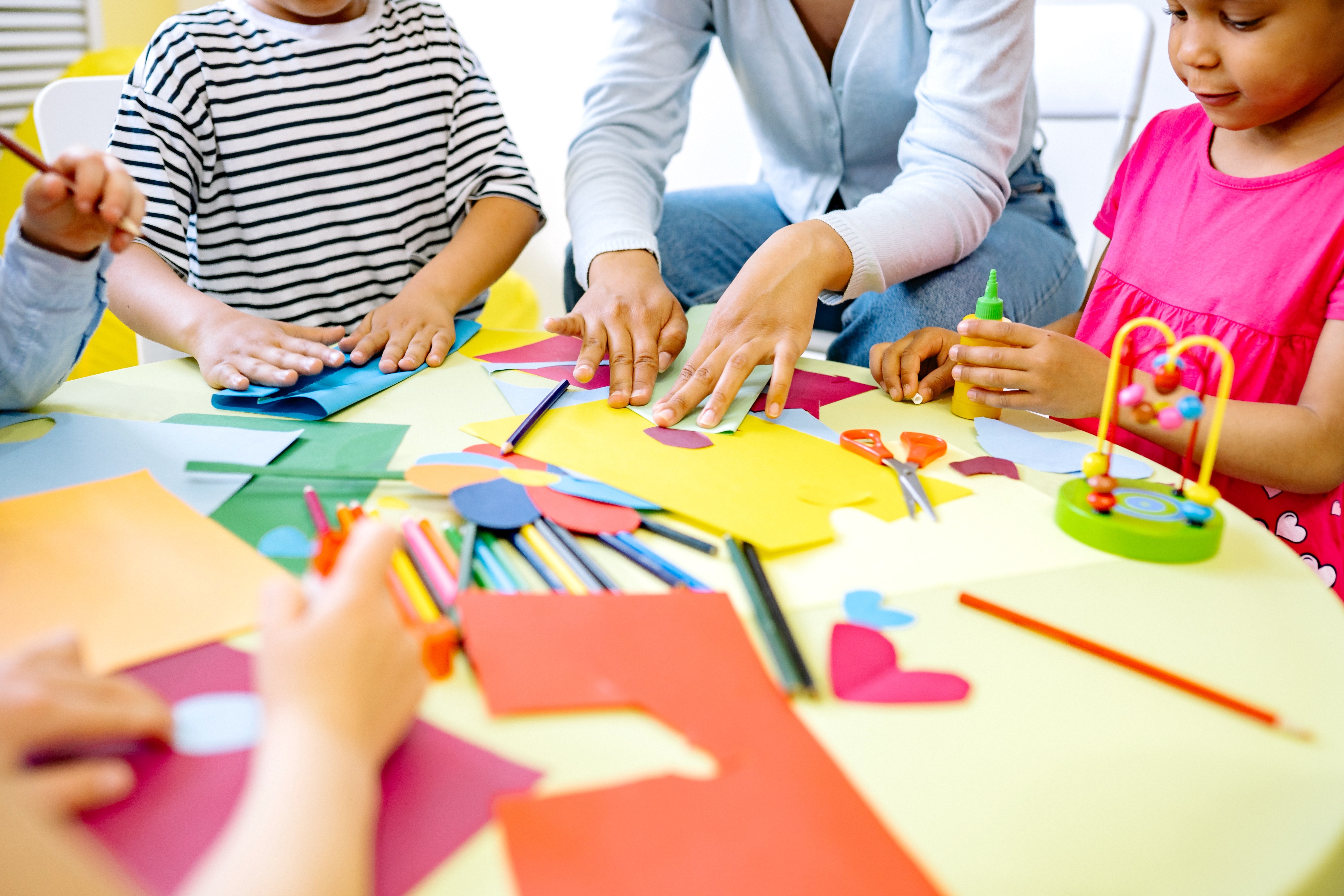 Group of Young Children and Adult Doing Arts and Crafts