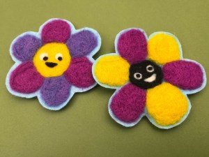 Felted flowers with smiley faces in the center