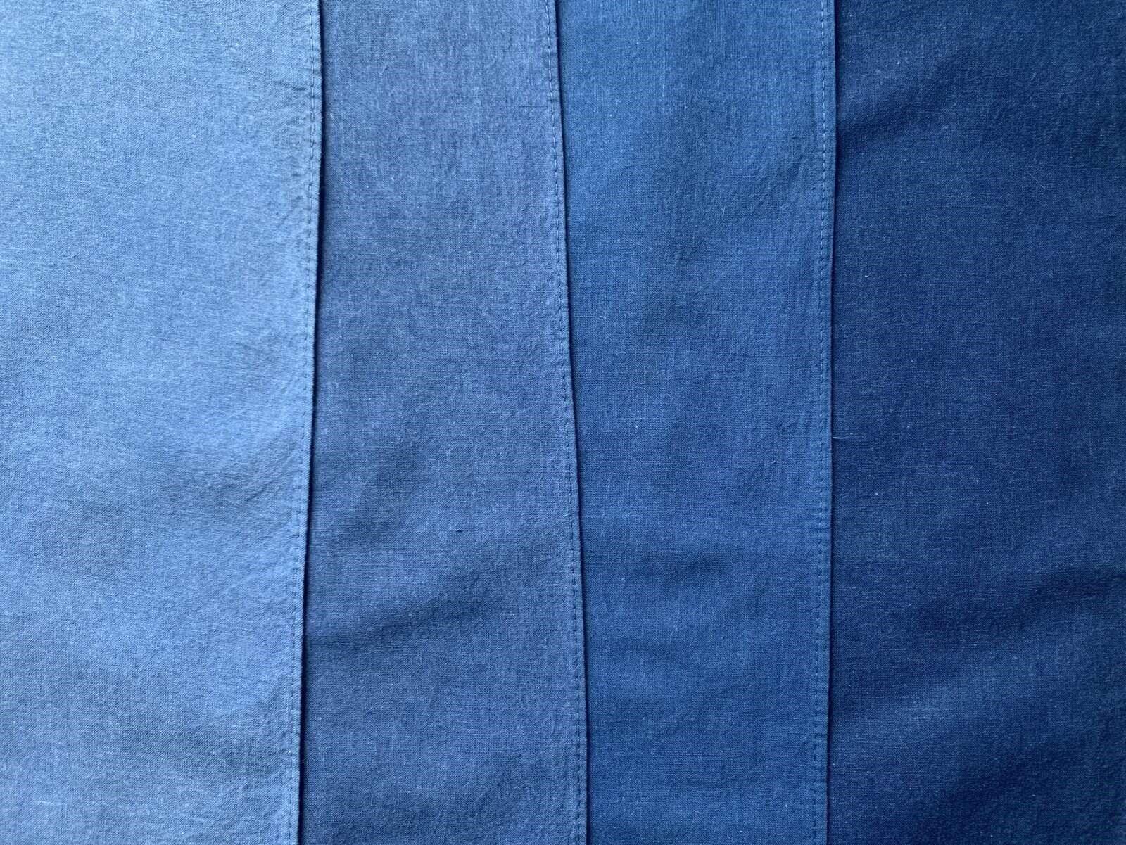 Gradations from light to dark of indigo dye on fabric.