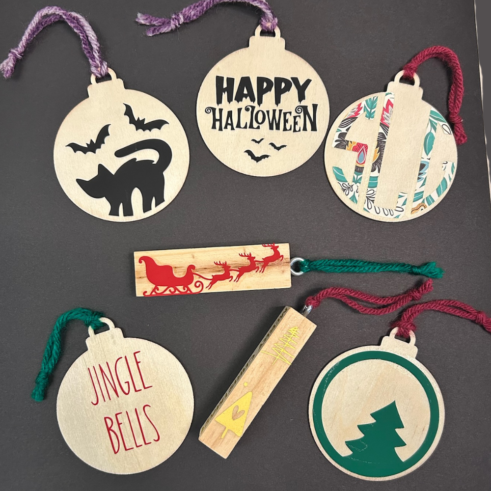Flat wooden ornaments with various colorful designs on the faces