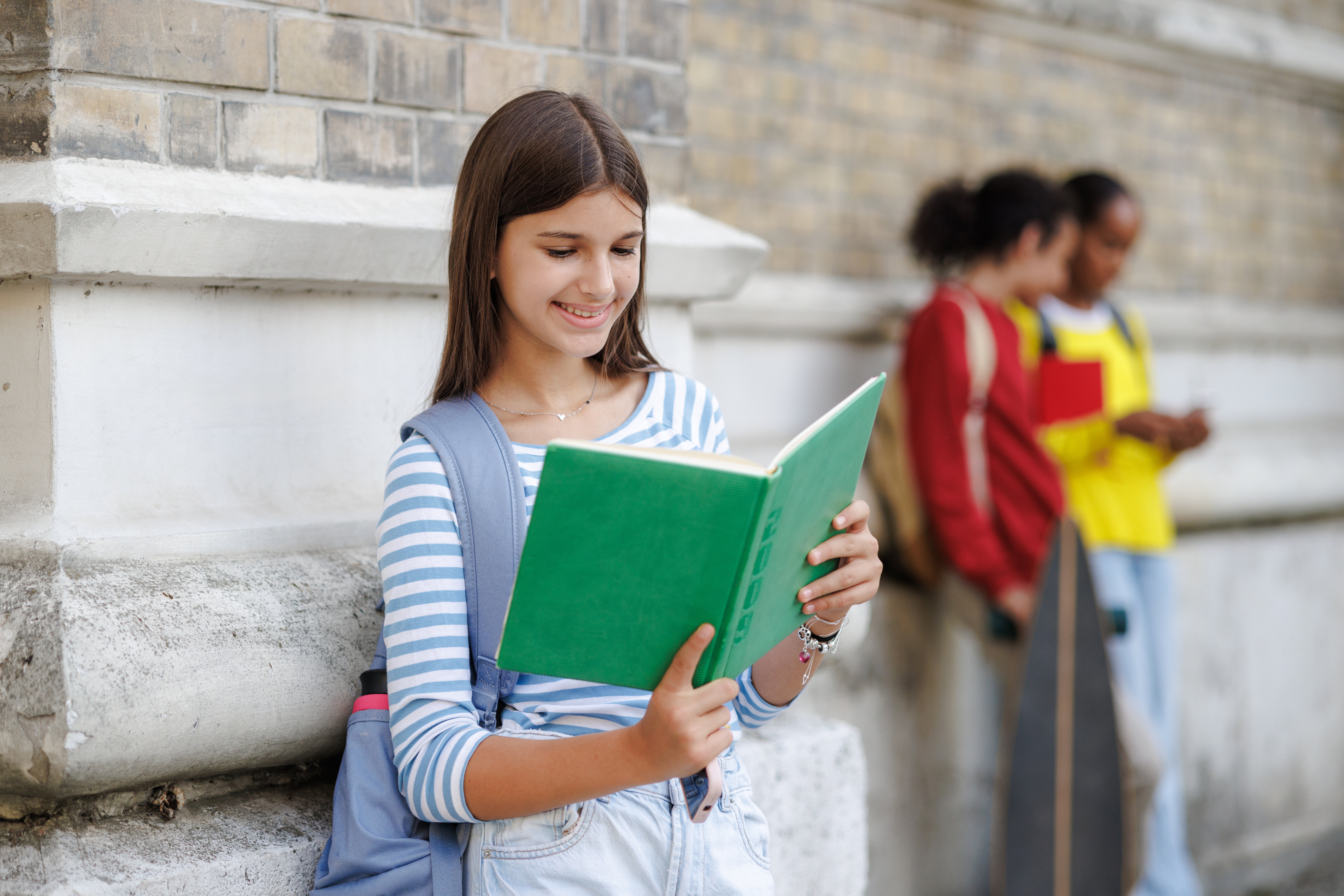 Teenage Girl Reading Book at Outdoors